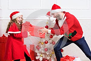 Kid cute girl play with father near christmas tree. Playful daughter and dad celebrate christmas. Winter activity and