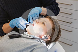 Kid in a dental clinic. Orthodontic treatment. Children's dentistry. boy in braces on his teeth at a dentist