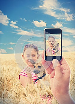 kid with a dog in wheat