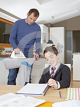 Kid doing homework, dad ironing.