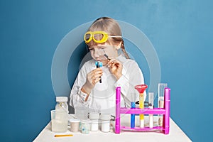 Kid doing science experiments. Child girl and science education