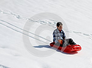 Kid down the descent with red bob