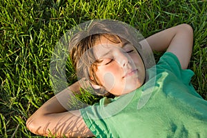 Kid dreaming on grass