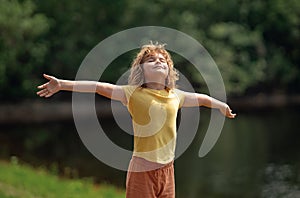 Kid dreams on future. Carefree kid dreaming outdoor. Childhood dream concept. Blonde cute daydreamer child dream on fly photo