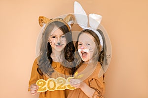 Kid dressed as tiger, girl in guise of rabbit - symbols of outgoing and new year