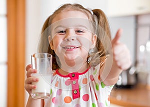 Kid drinking milk from glass