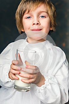 Kid drinks a glass of milk