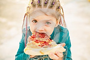 Kid eat pizza. Child eating pizza. Fastfood for kids. Italian junkfood. Children favorite food.