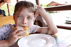 Kid eating adyghe halyuzh pie