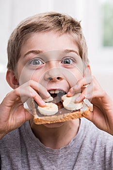Kid eating with appetite photo