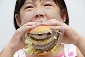Kid eating big burger