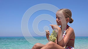 Kid Eating Grapes on Beach, Child Eats Fruits on Seashore, Blonde Little Girl Playing on Coastline, Sea Waves in Summer Vacation