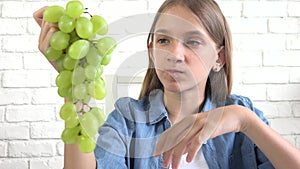 Kid Eating Grapes at Breakfast, Child Eats Fruits in Kitchen, Hungry Girl Eat Healthy Food for Diet, Children Healthcare Nutrition