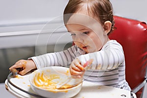 Kid eating, high chair and food, nutrition and health for childhood development and wellness. Healthy, growth and