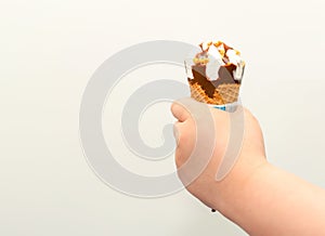 Kid eating ice cream wafer cone with happiness