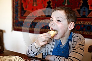 Kid eating khachapuri