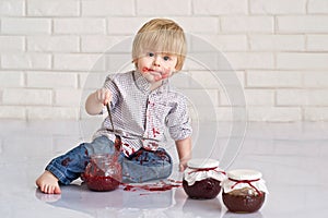 Kid eating strawberry jam