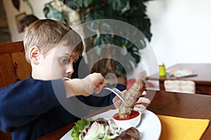 Kid eating veal lula kebab