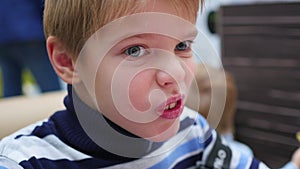 The kid eats a sandwich at a fast food restaurant closeup