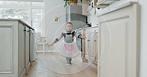 Kid, energy and ballet with dance in tutu for learning with skill in kitchen for growth or fun in home. Child, ballet