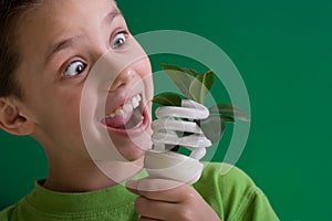 Kid with energy saving bulb