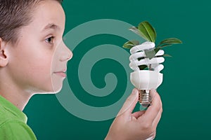 Kid with energy saving bulb