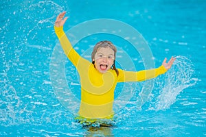 Kid enjoying summer holiday, swiming in pool. Kid having fun on summer holidays at pool. Happy kids playing on pool