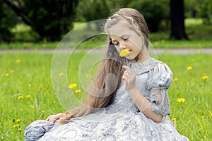 Kid enjoys flowers in the park