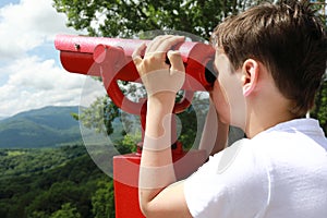 Kid examines Azish-Tau ridge through binoculars photo