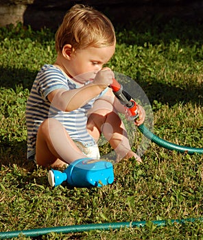 Kid exploring water hose
