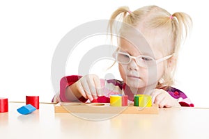 Kid in eyeglases playing logical game isolated photo