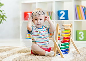 Kid with eyeglasses playing abacus