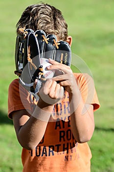 Kid with facial expressions playin baseball