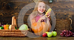 Kid farmer with harvest wooden background. Farm themed games and activities for kids. Child little girl celebrate