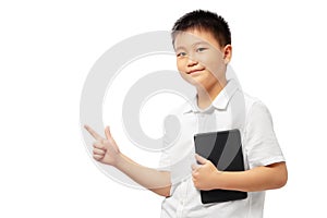 Kid with fingers presenting and pointing to the left, holding tablet, wearing white shirt