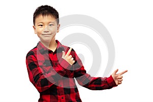 Kid with fingers presenting and pointing to the right, wearing red shirt