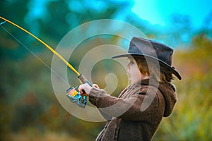 Kid fishing with spinning reel. Kids fly fishing.