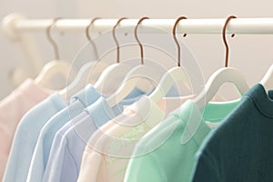 Kid friendly pastels Shirts hanging on rack, soft and inviting