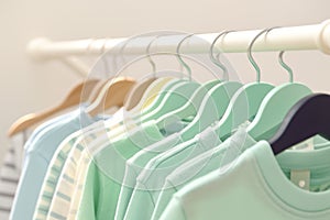 Kid friendly pastels Shirts hanging on rack, soft and inviting