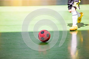 Kid futsal player trap and control the ball for shoot to goal