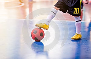 Kid futsal player trap and control the ball for shoot to goal