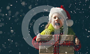 Kid with gift box on dark background