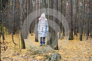 KId girl in the autumn forest