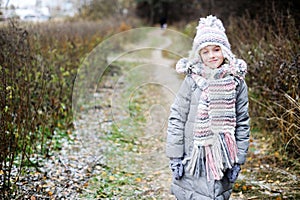 KId girl in the autumn forest