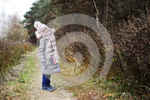 KId girl in the autumn forest