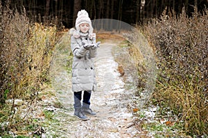 Kid girl in the autumn forest