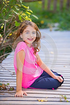 Kid girl in autumn smiling with braces teeth apparatus photo