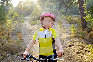 Kid girl biker in mountain bike MTB photo