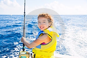 Kid girl boat fishing trolling rod reel and yellow life jacket