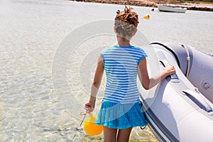 Kid girl in boat at formentera Estany des Peix photo